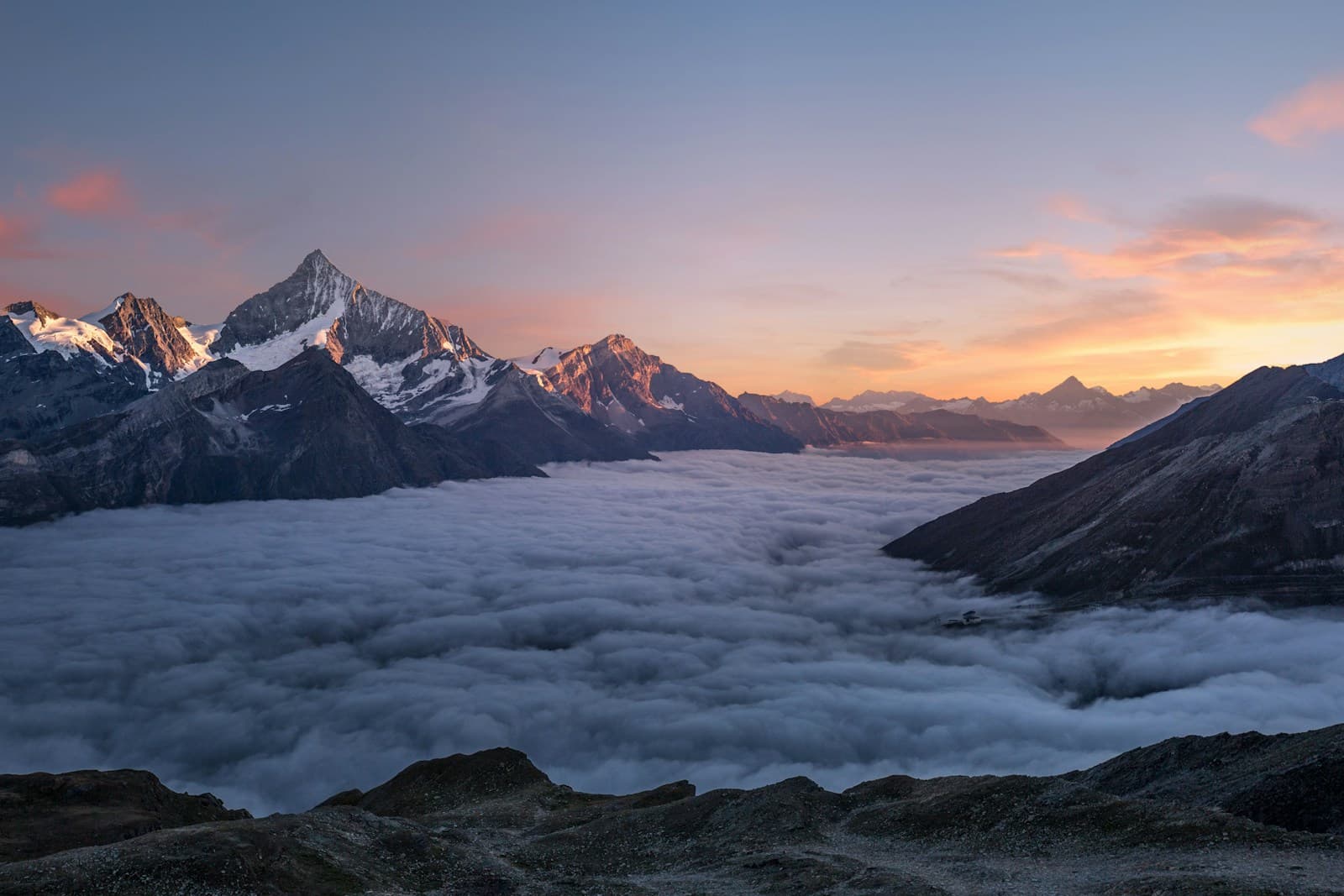 Travelers overlooking a mountain landscape